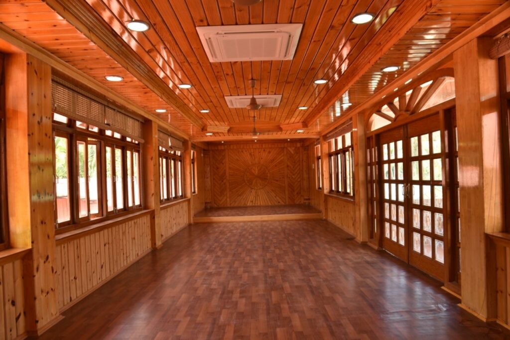Wood-finished multipurpose and conference space at Lush Green Retreat