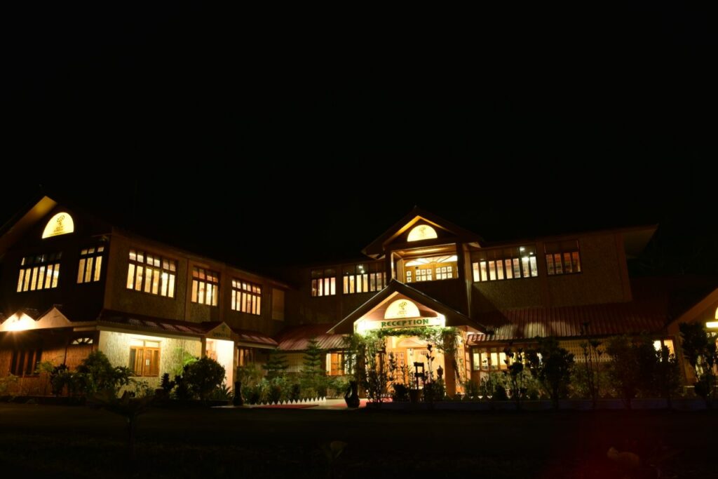 Night view of the reception and administrative building at Lush Green Retreat